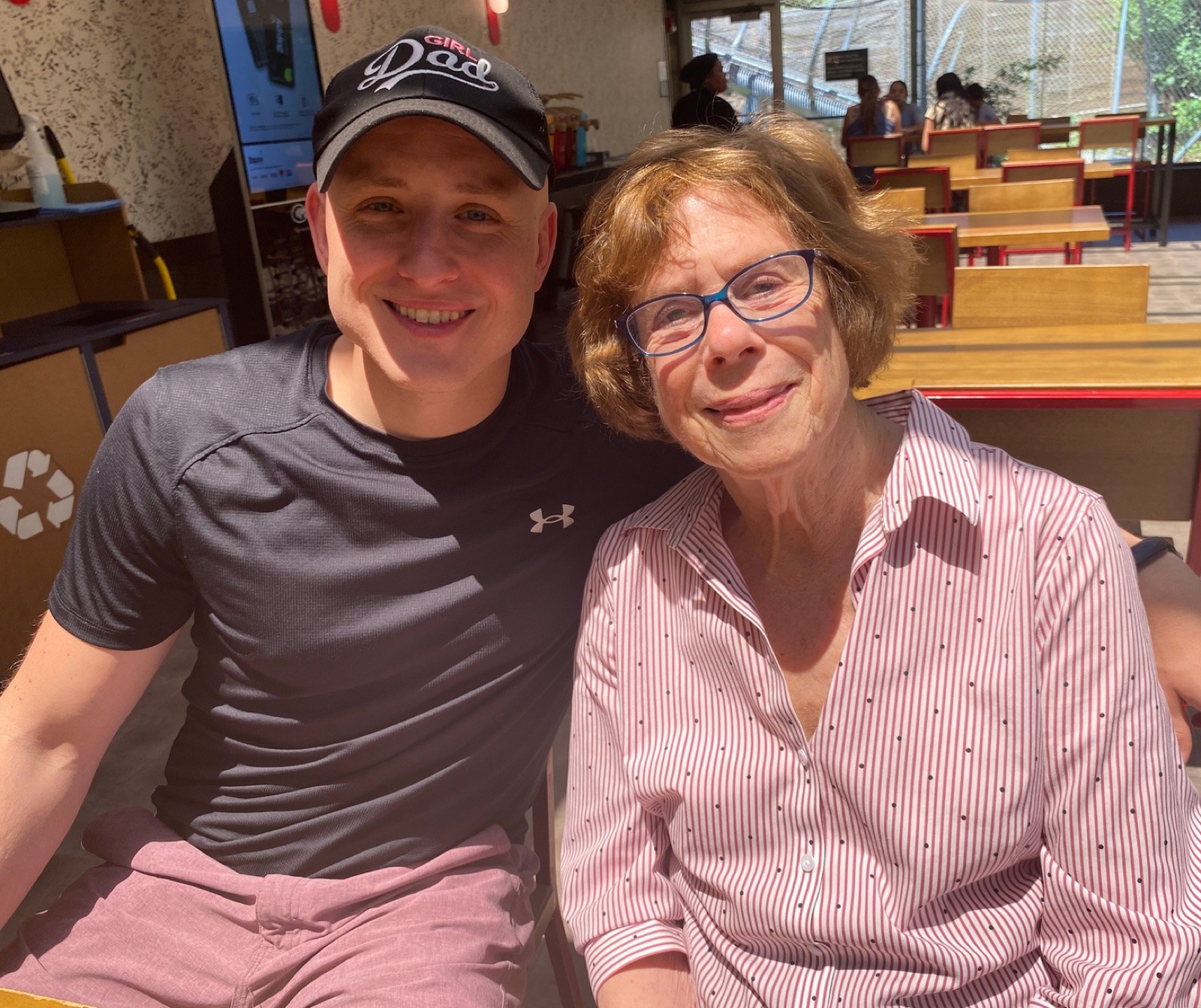 Me with my 85-year-old college mentor at a restaurant